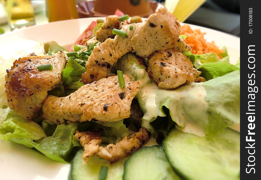 A mixed summer salad with chicken. A mixed summer salad with chicken