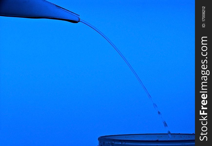 Pure water coming from a laboratory bottle and falling into another glass. Pure water coming from a laboratory bottle and falling into another glass