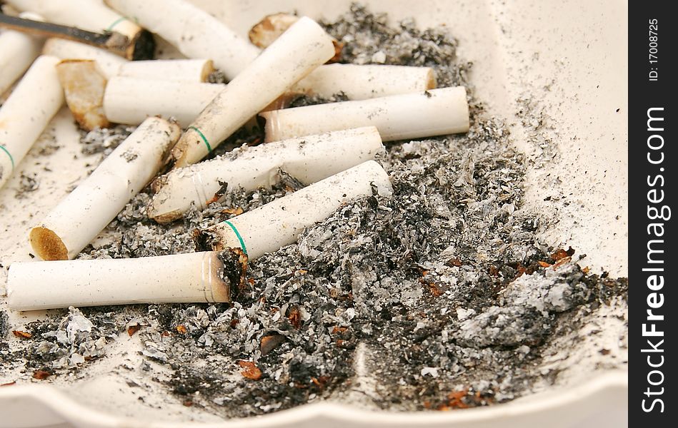 Withdrawing white cigarettes ashtray stub