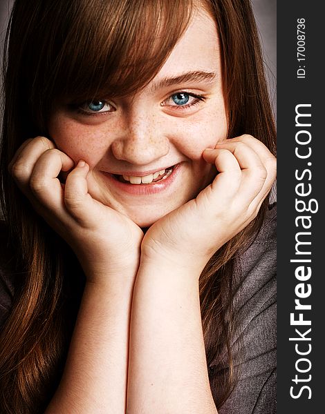 A beautiful young girl smiling to the camera. A beautiful young girl smiling to the camera.