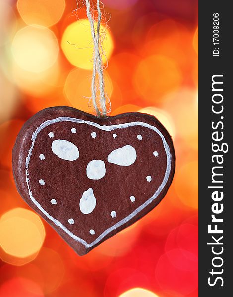 Gingerbread cookies heart decoration against blurred background. Gingerbread cookies heart decoration against blurred background
