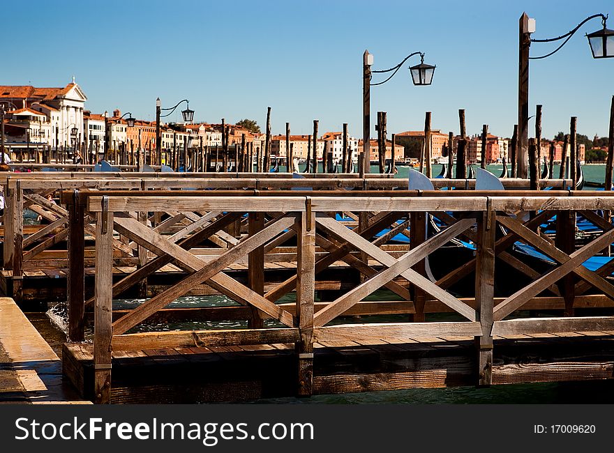 Boat (gondola) landing in Venice with a wooden railing. Boat (gondola) landing in Venice with a wooden railing