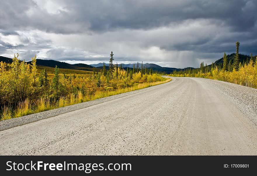 A storm gathers in the distance along the Dempster Highway in Yukon Territory. A storm gathers in the distance along the Dempster Highway in Yukon Territory