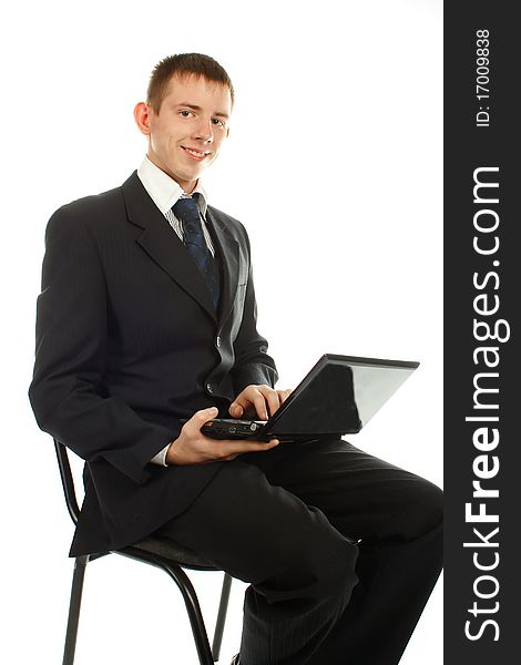 The businessman on the chair with laptop