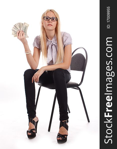 Businesswoman with money on the office chair on white background. Businesswoman with money on the office chair on white background.