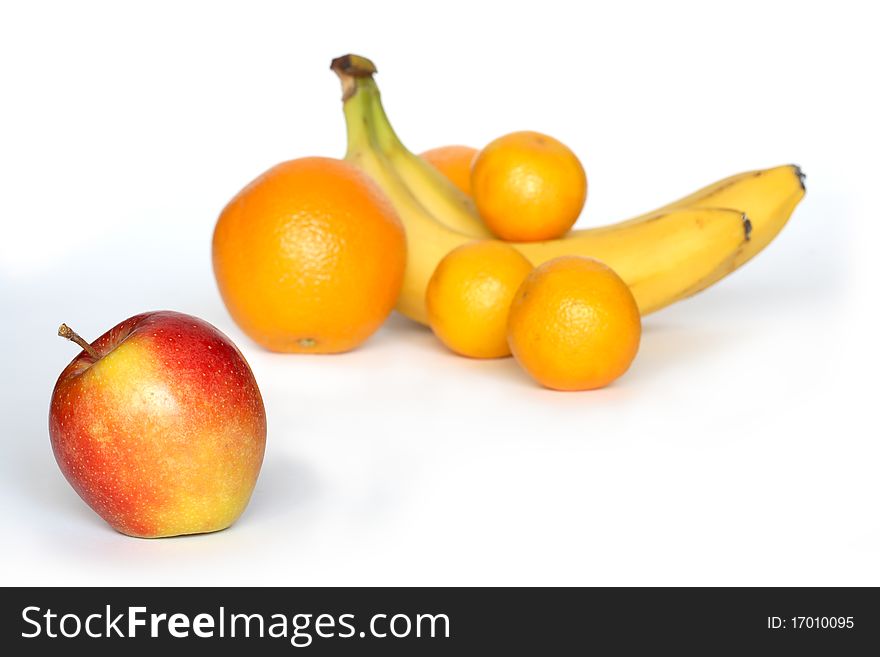 Red apple lying on white background with various fruits. Red apple lying on white background with various fruits