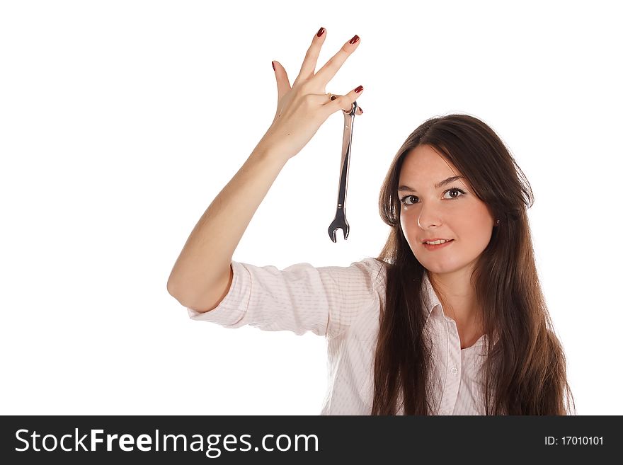 The woman with the spanner wrench on the white background. The woman with the spanner wrench on the white background.