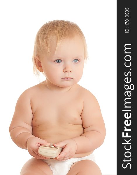 Portrait of happy young sitting baby with phone in hand
