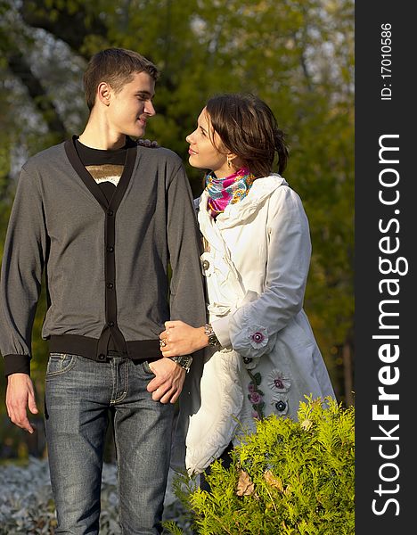 Young couple looking at each other eyes over defocused background. Young couple looking at each other eyes over defocused background