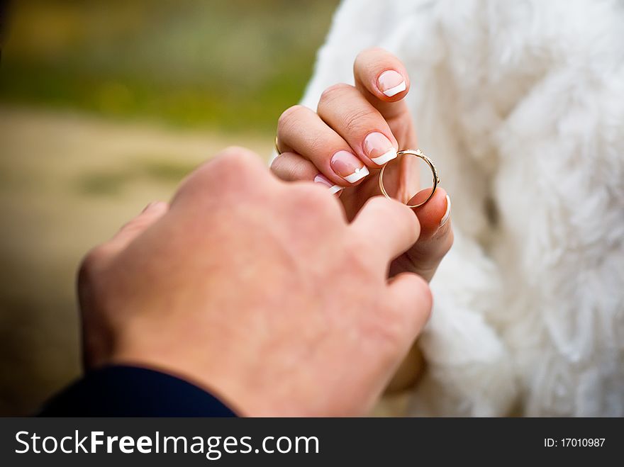 Putting on a wedding ring outdoors