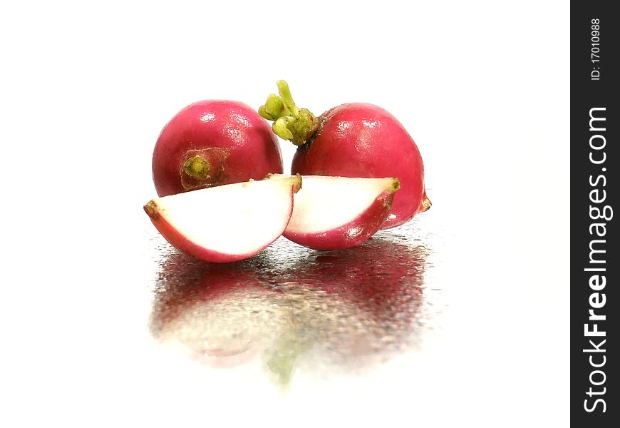 Radish on the white background with water drops