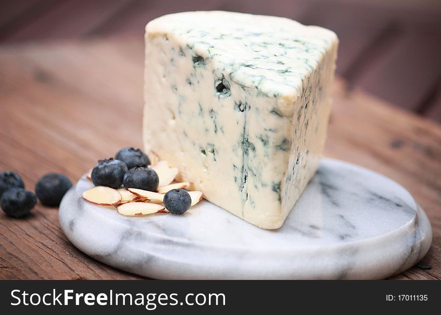 Slice of blue cheese on marble platter