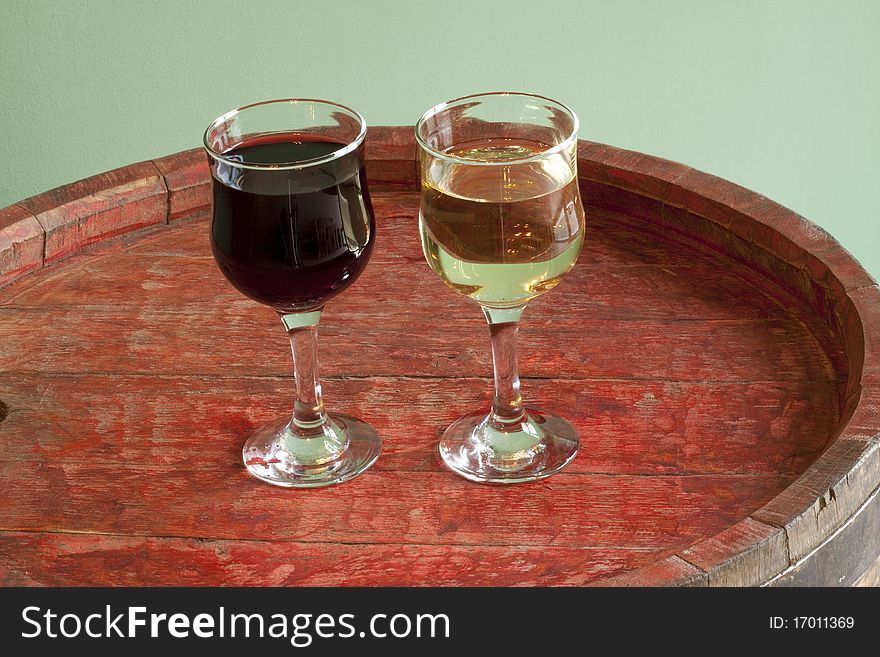 Two glasses of wine on a barrel. Two glasses of wine on a barrel