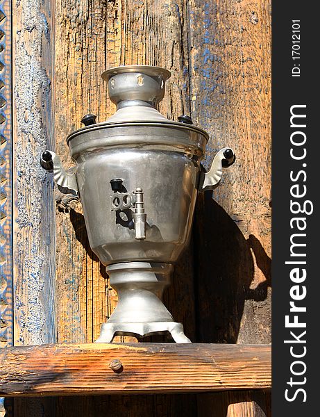 Tea-urn outside of an wooden house. Tea-urn outside of an wooden house.