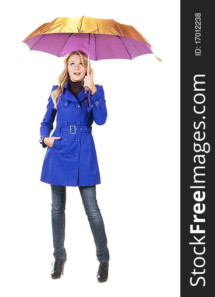 Lovely surprised woman in a blue coat with umbrella against white background. Lovely surprised woman in a blue coat with umbrella against white background