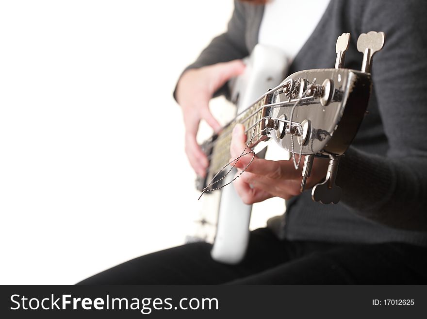 Playing electrical bass guitar isolated on white