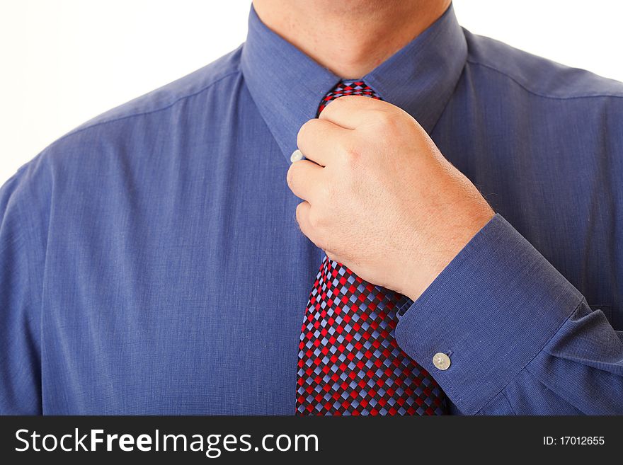Businessman adjusting his tie blue