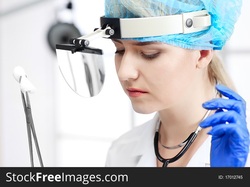 Beautiful woman doctor in uniform in cabinet