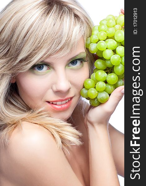 Beautiful woman over white background with grape. Beautiful woman over white background with grape