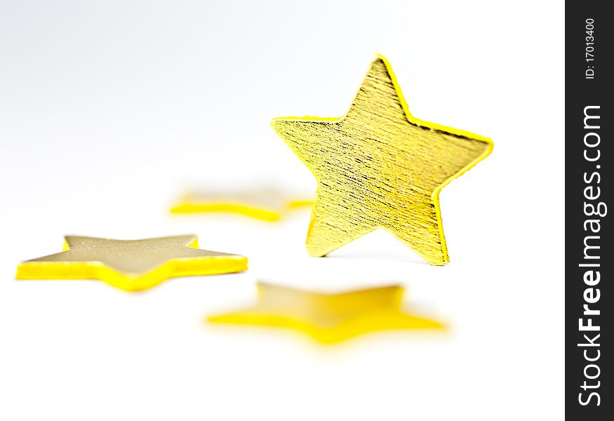 On a white background golden stars, one star in a vertical position. On a white background golden stars, one star in a vertical position.