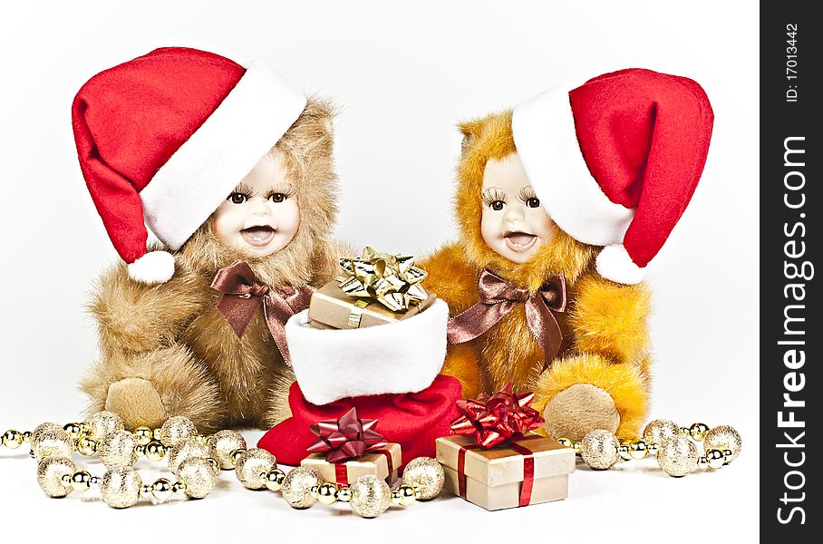 On a white background are two porcelain bears a Christmas gift bag and a golden ball strings. On a white background are two porcelain bears a Christmas gift bag and a golden ball strings.