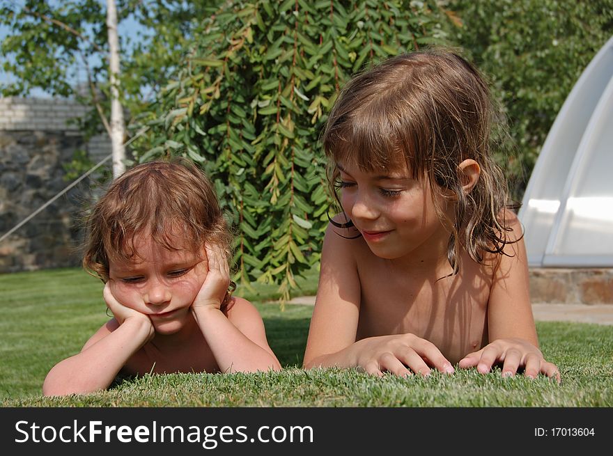 Two little girls playing in garden. Two little girls playing in garden
