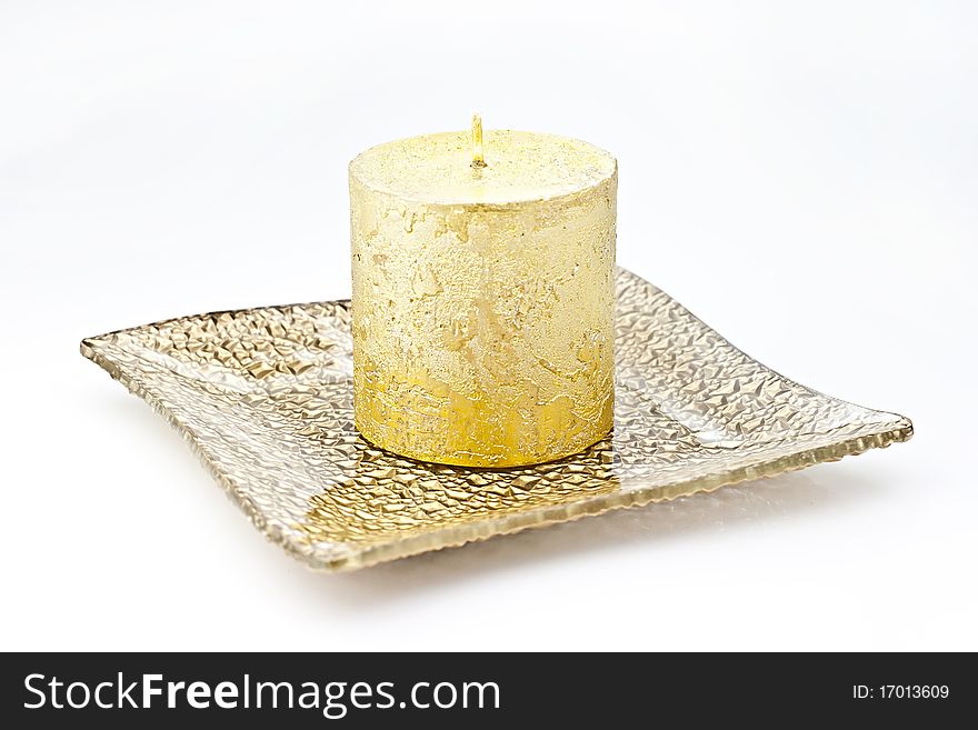 Isolated on white background gold candle in a glass dish. Isolated on white background gold candle in a glass dish.