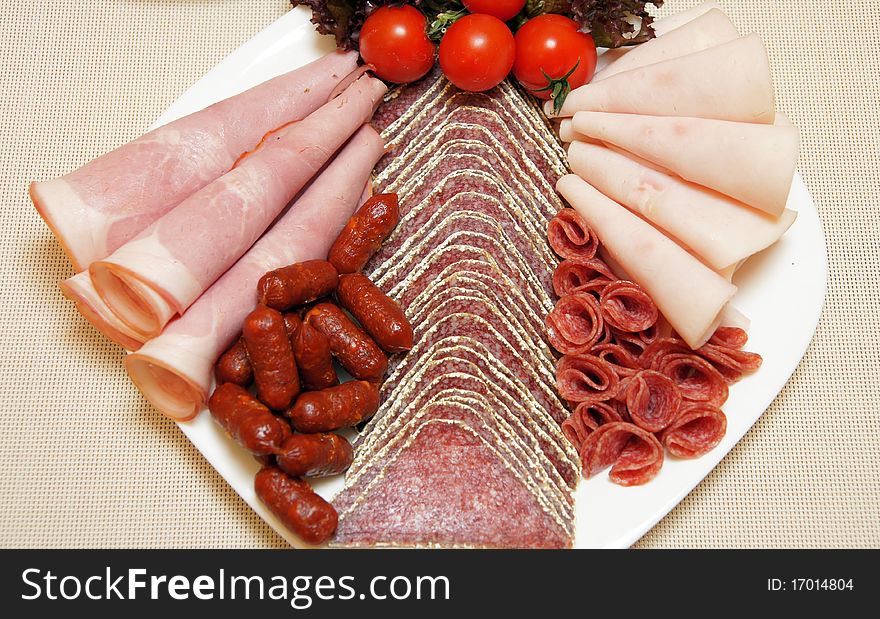 Salami plate, mini sausages, ham - food styling