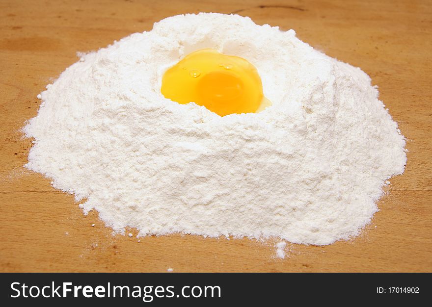 Flour and egg on the board. Flour and egg on the board