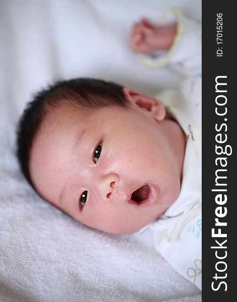 Portrait of a cute little new born baby boy,cheer up