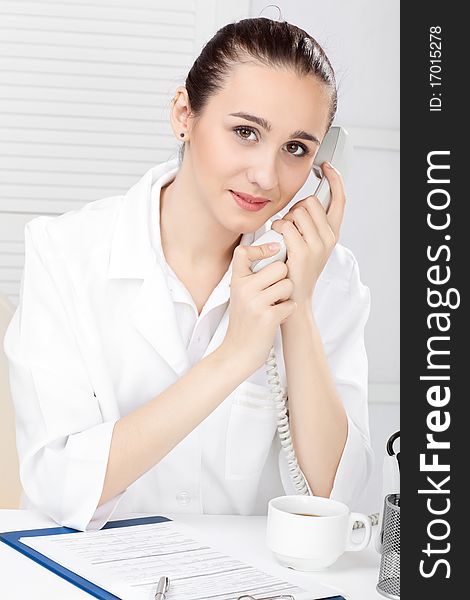 Female medical doctor working with a microscope. Female medical doctor working with a microscope