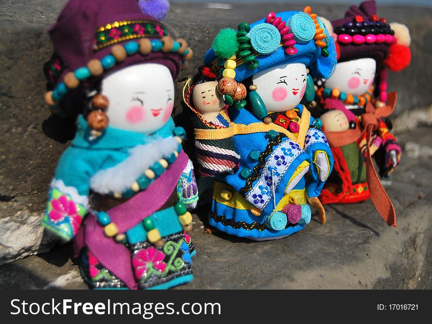 Three chinese minority dolls,they wear traditional clothes and smiling. Three chinese minority dolls,they wear traditional clothes and smiling.
