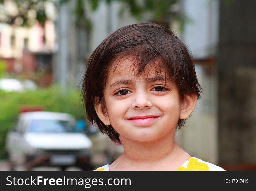 A beautiful and cheerful smile of a small Indian girl. A beautiful and cheerful smile of a small Indian girl