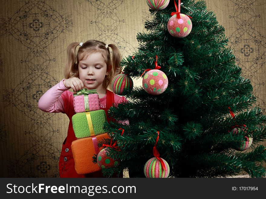 A little girl with three boxes with presents. A little girl with three boxes with presents