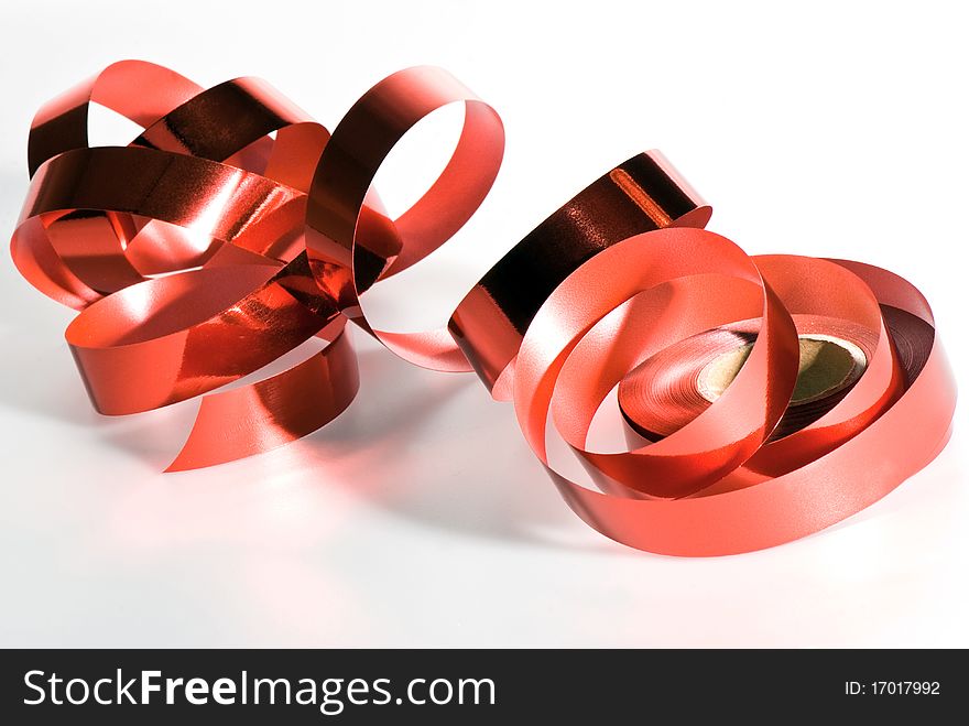 Red glossy tape for packing of gifts it is isolated on a white background