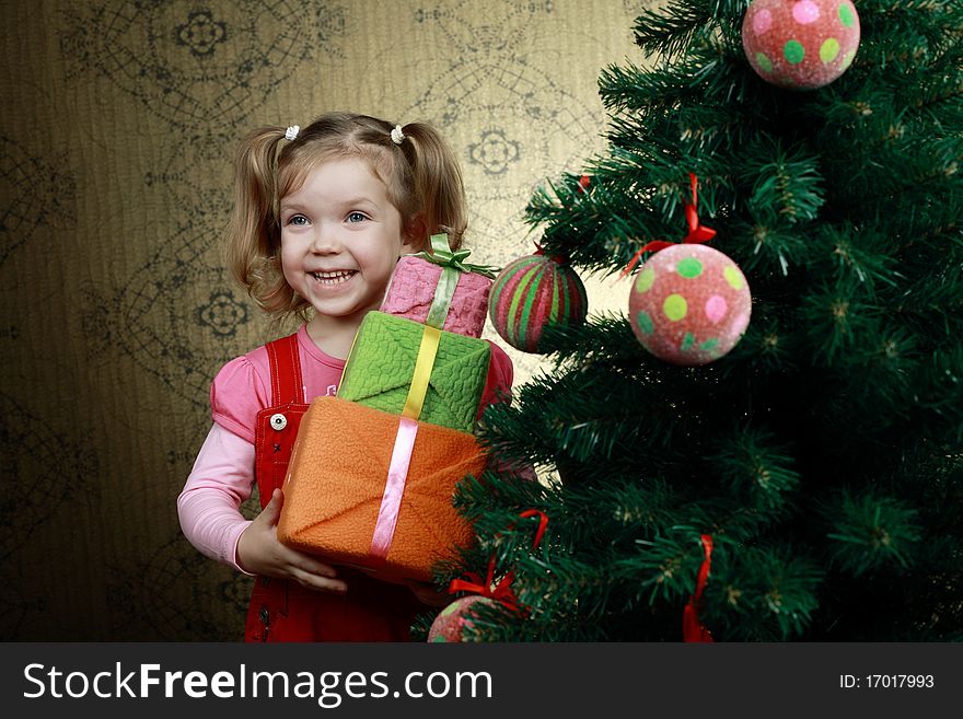 A little girl with three boxes with presents. A little girl with three boxes with presents