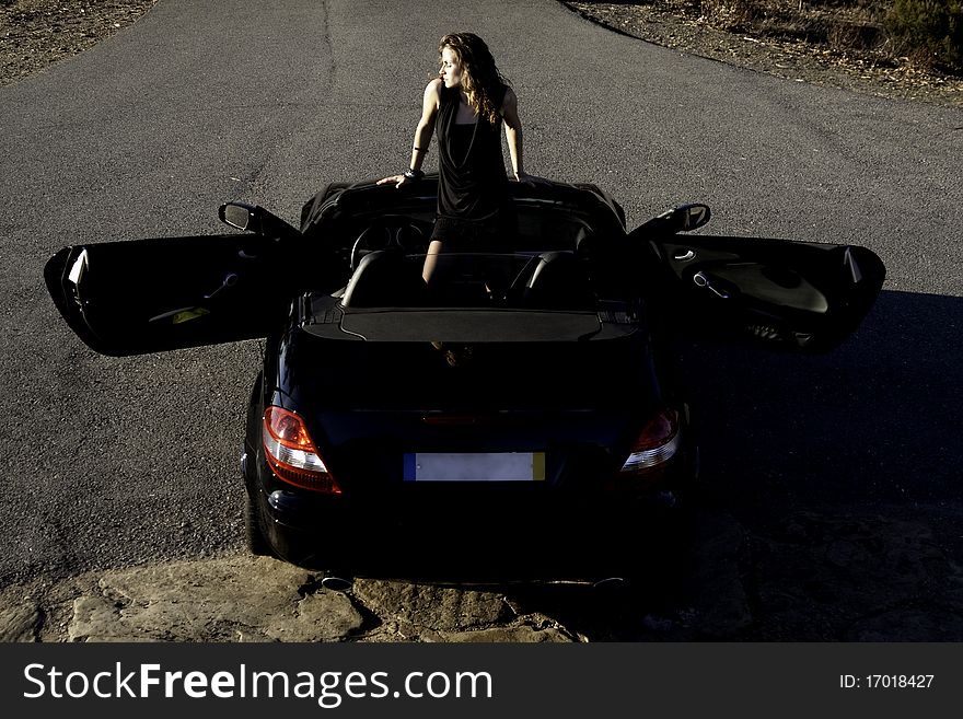 View of a beautiful woman inside a sports car. View of a beautiful woman inside a sports car.