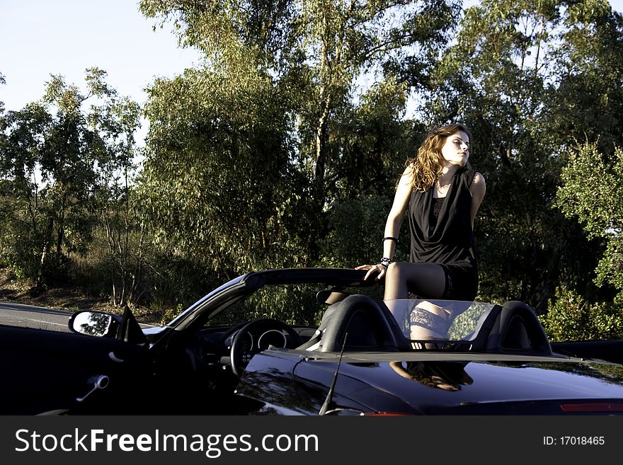 View of a beautiful woman inside a sports car. View of a beautiful woman inside a sports car.