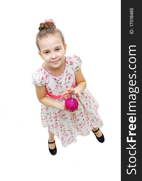 High angle view of a little cute girl playing with a tree-decoration ball. High angle view of a little cute girl playing with a tree-decoration ball