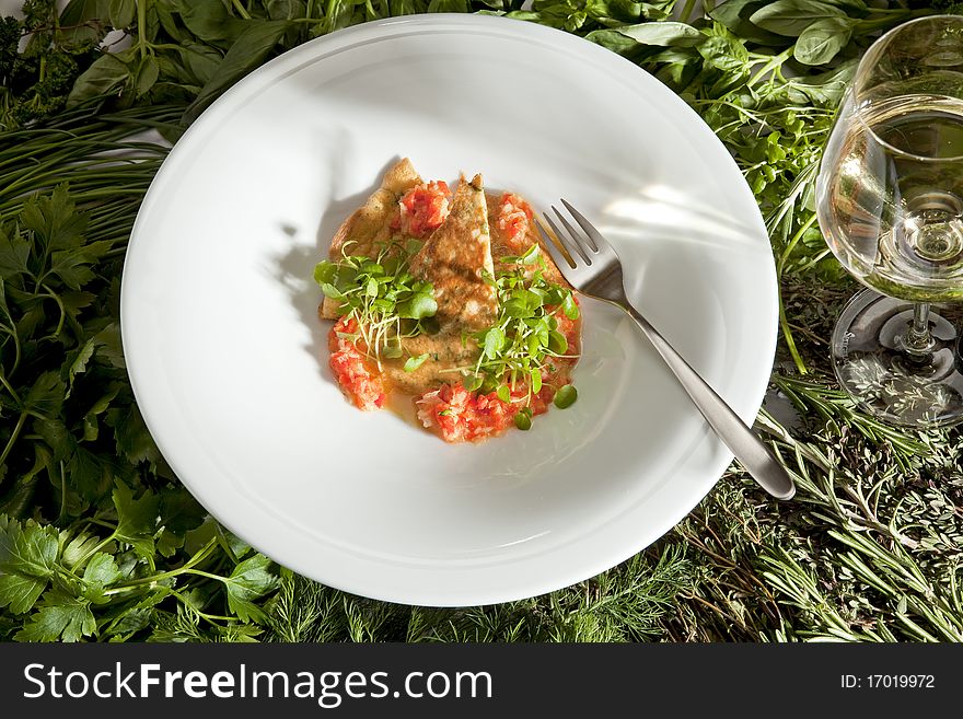 Paprika vinaigrete on a white plate with white wine.