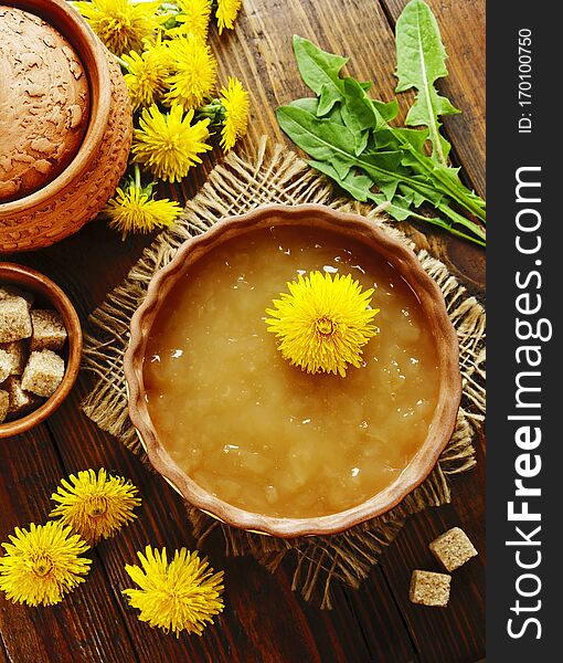 Jam of dandelions on the wooden table