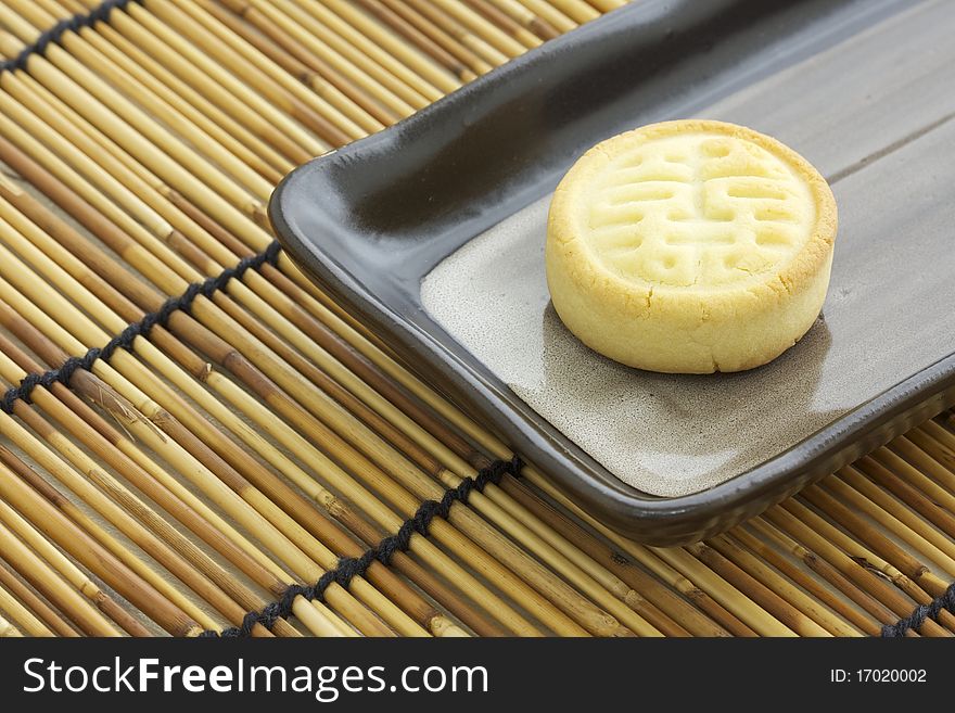 Delicious chinese cake for tea time snack on rectangular plate. Delicious chinese cake for tea time snack on rectangular plate