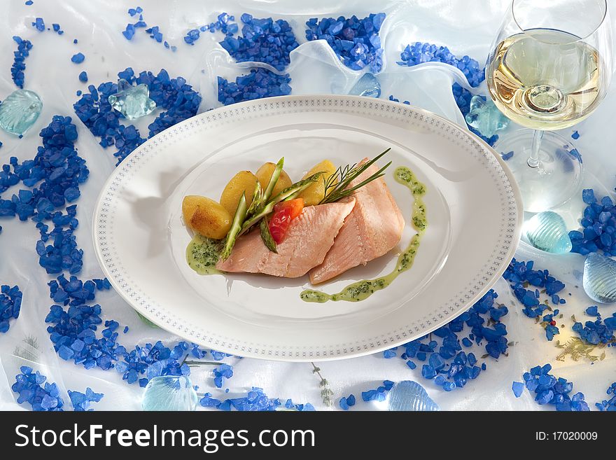 Salmon trout with herbal sour cream and a glass of white wine