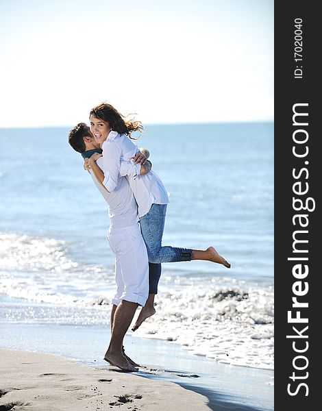 Happy young couple in white clothing  have romantic recreation and   fun at beautiful beach on  vacations. Happy young couple in white clothing  have romantic recreation and   fun at beautiful beach on  vacations