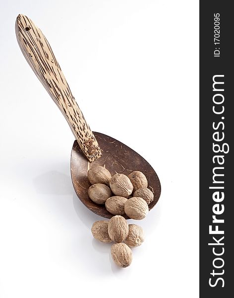 Isolated wooden Spoon with on nutmeg it. Isolated wooden Spoon with on nutmeg it.