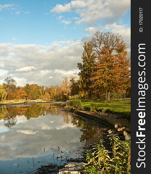 Colorful fall park with pond