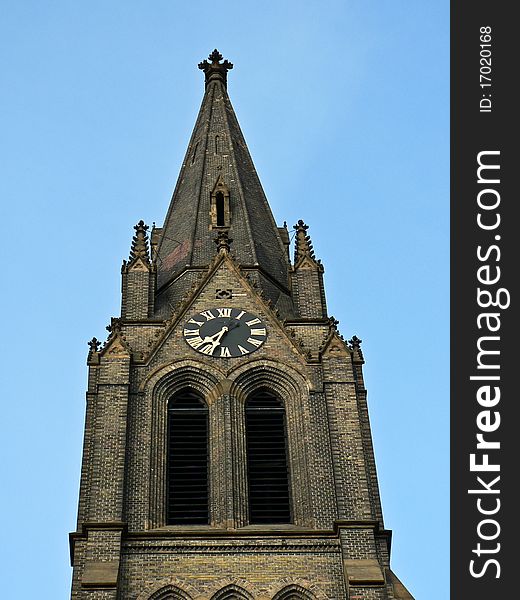Neogothic steeple with blue sky in background