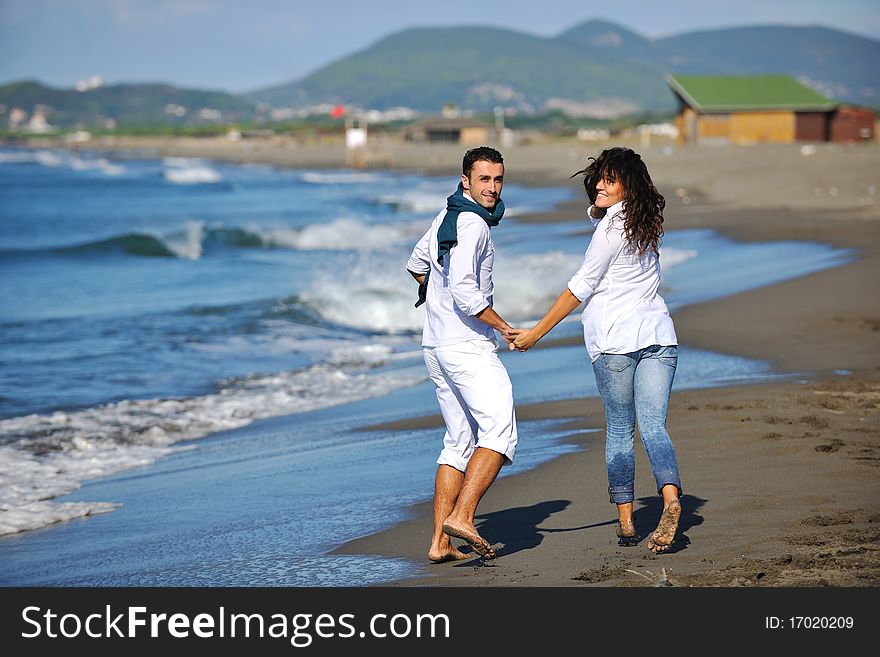 Happy young couple in white clothing have romantic recreation and fun at beautiful beach on vacations. Happy young couple in white clothing have romantic recreation and fun at beautiful beach on vacations