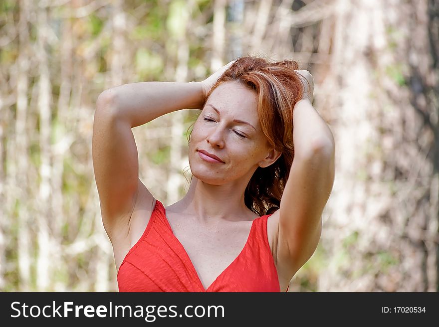Portrait of red-haired adult woman in nature. Portrait of red-haired adult woman in nature