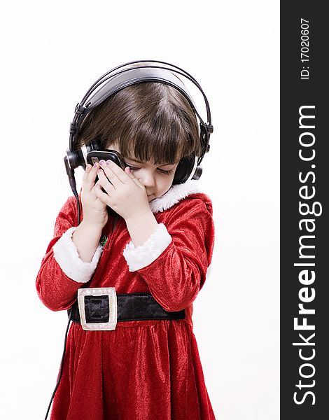 Christmas child with sell phone and headphones. Christmas child with sell phone and headphones